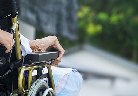 Lato sedia a rotelle con braccio anziana