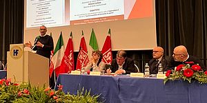 Ricci e rappresentanti CGIL al tavolo sotto lo schermo