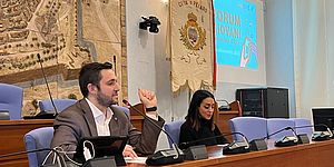 Perugini Murgia e dietro il cartellone Forum Giovani